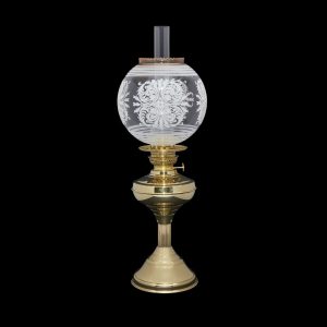 An Embossed White Leaf Motif Pattern Globe oil lamp shade, on a brass Regency style table lamp with chimney.
