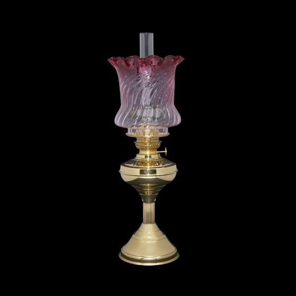 Cranberry to Clear Tulip oil lamp shade on a brass Regency style table lamp with chimney